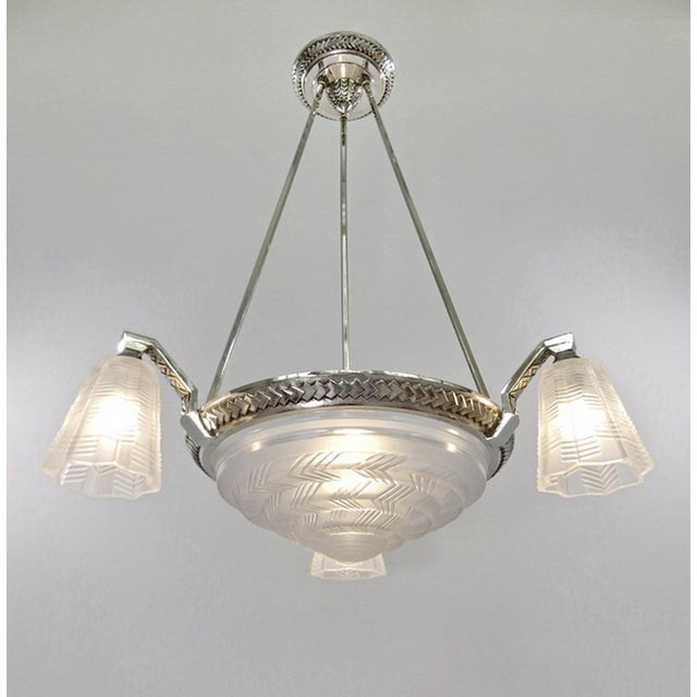 H. Petitot A French art deco chandelier by Hubert Petitot (c. 1935) in nickel plated bronze or solid brass with four...