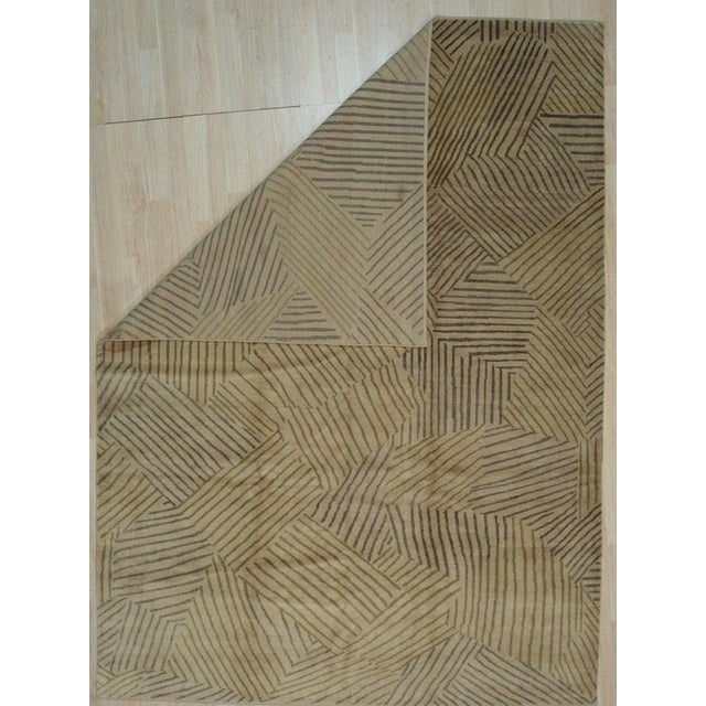 This hand knotted pile rug features a primary brown earth tone palette and is crafted from wool. Designed in the Nain...