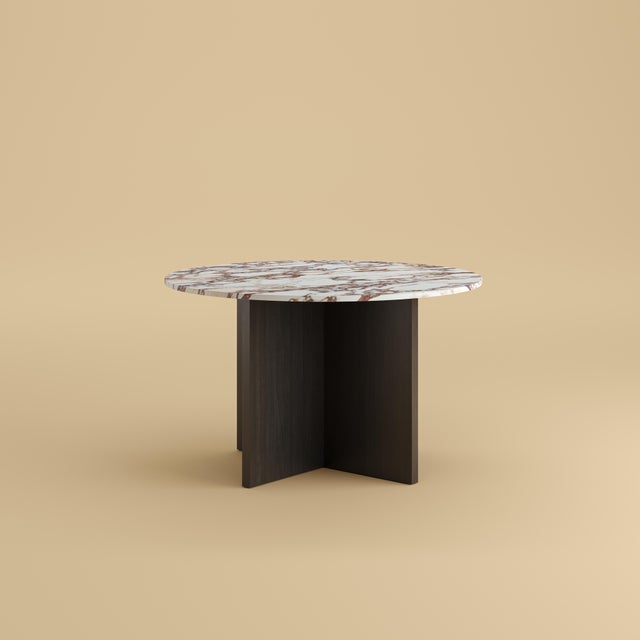 Arabescato Vagli marble over a base of solid oak gives the Hakata its balance. It is a table scaled for a room and its...