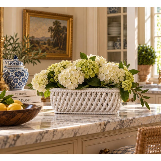 An elegant trompe l'oeil porcelain cachepot crafted in the form of a handwoven rope basket. Executed in glossy white...