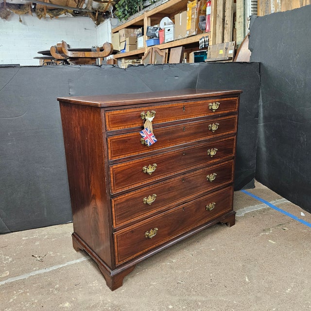 This is a beautiful example of English Mahogany Satin Banded & inlaid 5 Drawer Chest on Bracket Feet. The brass handles...