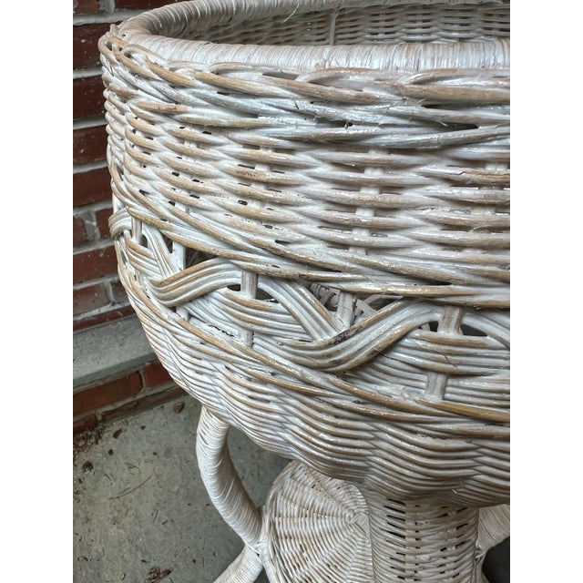 Love the soft white washed color of this vintage wicker planter. The planter is one single piece. Sculptural legs and a...
