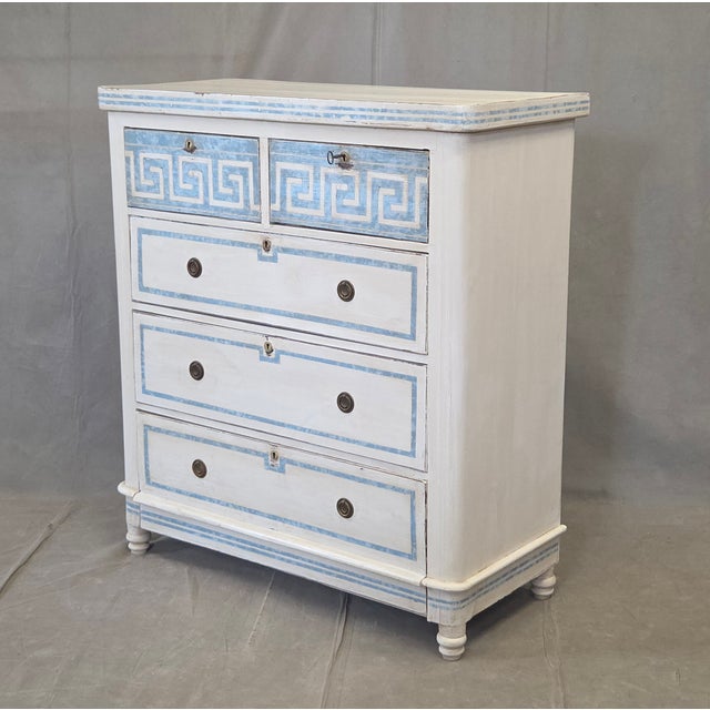 An absolutely stunning antique hand painted dresser with distressed antique white paint and blue French line motif. The...
