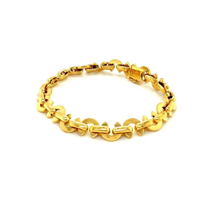 This chic and elegant bracelet is part of Chanels Logo Collection, crafted from solid 18k yellow gold. The design...