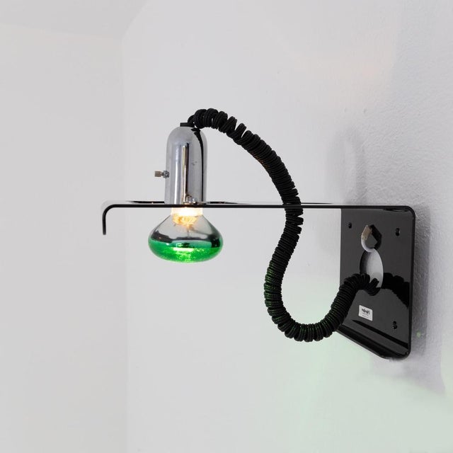 Painted metal wall lamp with upward or downward adjustable bulb, model “Squadra” designed by Ezio Didone and produced by...