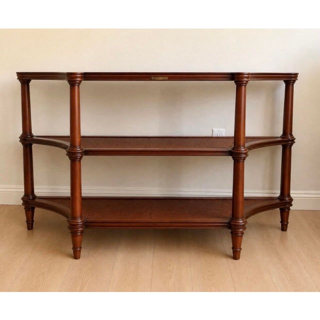 Bring timeless elegance to your home with this vintage Ethan Allen Legacy Collection three-tier console table. Crafted...