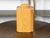 A tin canister from the 19th century, with faux bois finish and canted corners. Created during the 19th century, this...
