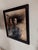 This oil on wood painting features two figures, their expressions intertwined with a sense of introspection and...