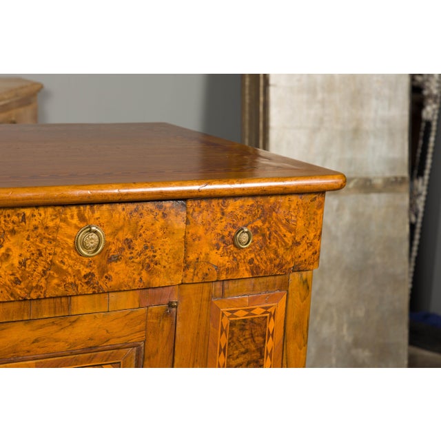 A French walnut buffet from the 19th century with burled accents, doors inlaid with diamond motifs and ogee bracket feet....