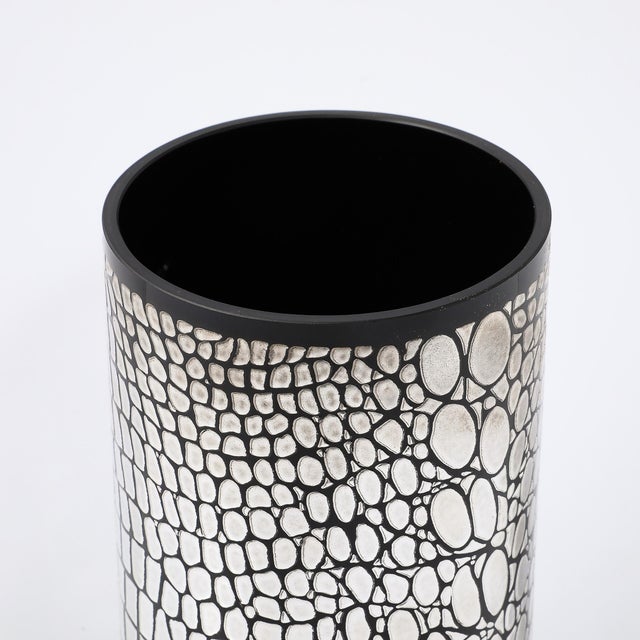 This Mid-Century Modernist black glass vase, crafted in Italy circa 1980, is a visually striking piece that beautifully...