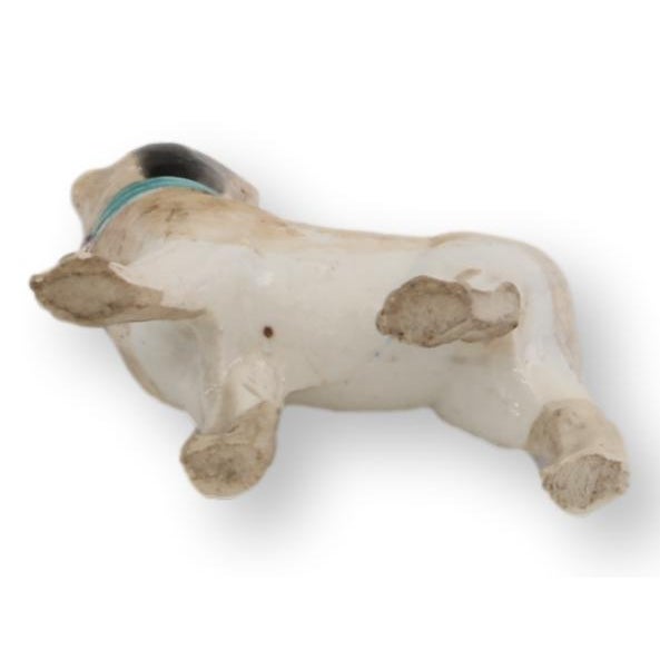 Mid 19th century English Staffordshire porcelain pug figure featuring a cheerful stance, curled tail, and hand-painted...