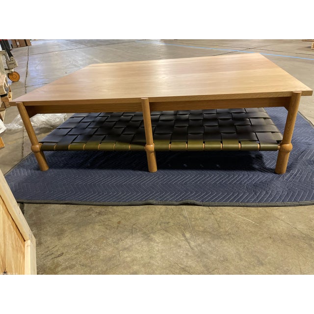 - Hand turned, solid wood legs and cross members - Solid wood top - Veg tan woven leather shelf - Wood: White Oak -...