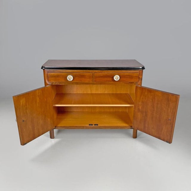 Italian Art Deco wooden dresser two drawers with glass transparent handles 1940s Wooden sideboard or cupboard. The top of...
