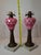 This offering features a rare and beautiful pair of mid-19th-century glass lamp fonts, likely American (Boston & Sandwich...