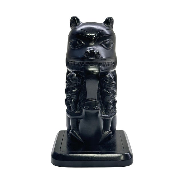 A vintage hand-carved totem pole sculpture by Boma, depicting a stylized crest figure inspired by the Indigenous art...