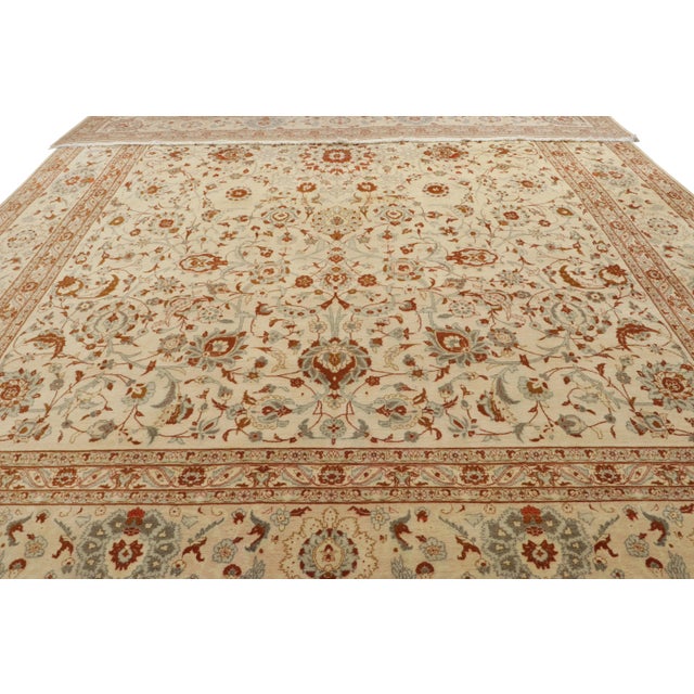 Hand-knotted in wool, circa 1950-1960, this 13x21 oversized vintage rug originates from the titular city of Isfahan and...