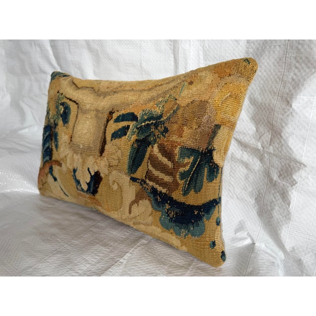 An exceptional decorative pillow handcrafted from an authentic 17th-century Flemish Verdure tapestry fragment, preserving...