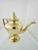 A beautiful gold tinted bronze alloy tea pot in the Hollywood Regency style.