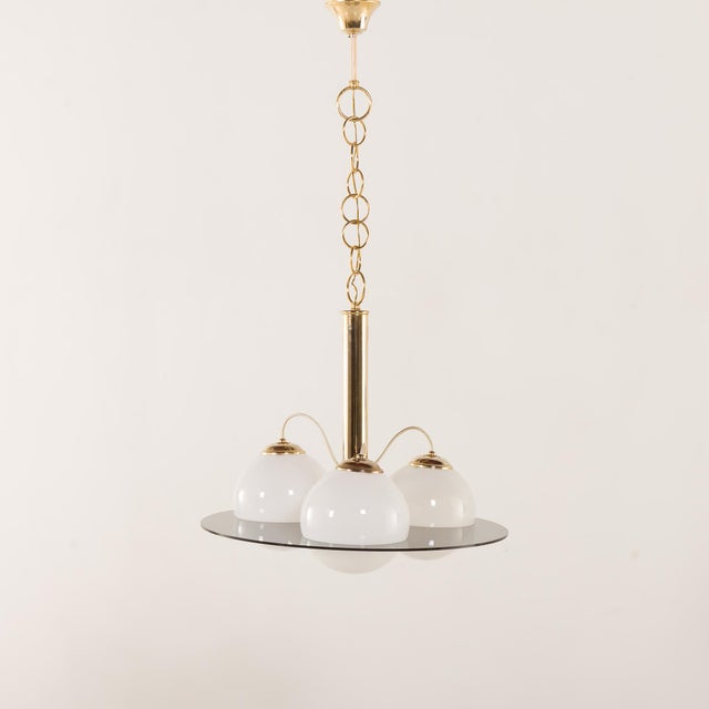 This rare mid century chandelier incorporates a few Italian styles. It feature Space Age shapes with materials...