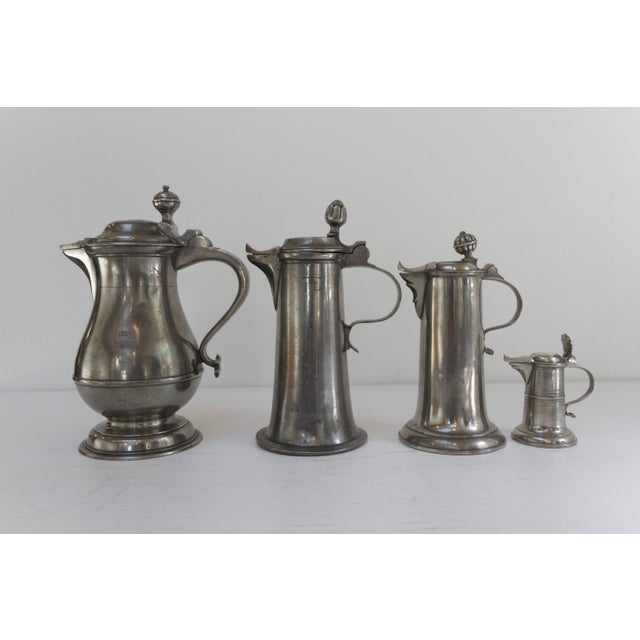 Antique German Pewter Tankards, early 19th century. Set of 4. Highly decorative set of four German jugs or tankards with...