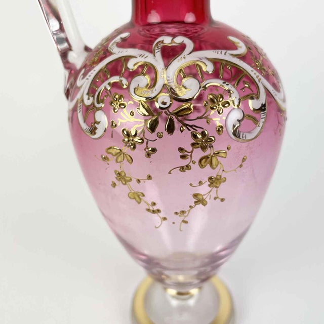 A gilded metal liquor set with a flower vase, from the late 19th century. The glass consists of a mirrored top held by a...