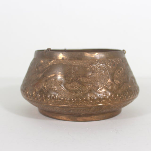 Small chased copper hanging planter bowl. You could also put a candle it and use as a lantern. This has a repoussé scene...