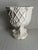 A single white ceramic cachepot or footed vase featuring nautical rope style relief decoration with a sea serpent base.