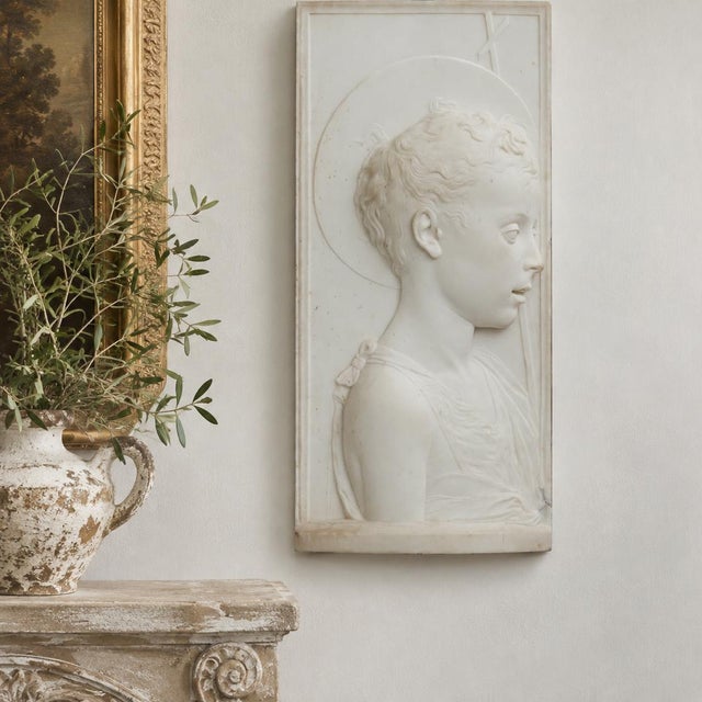 YOUNG SAINT JOHN THE BAPTIST After Desiderio da Settignano Italian, circa 1860 22" H x 2" D x 9 1/2" W Carved white marble...