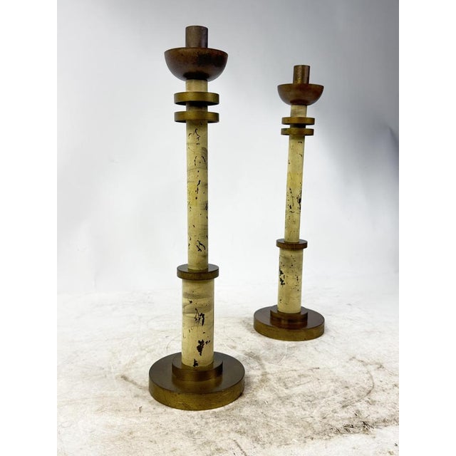 Elegant set of 2 Art Deco brass pillar candle holders with ivory finish and gold details, ideal as a furnishing accessory...