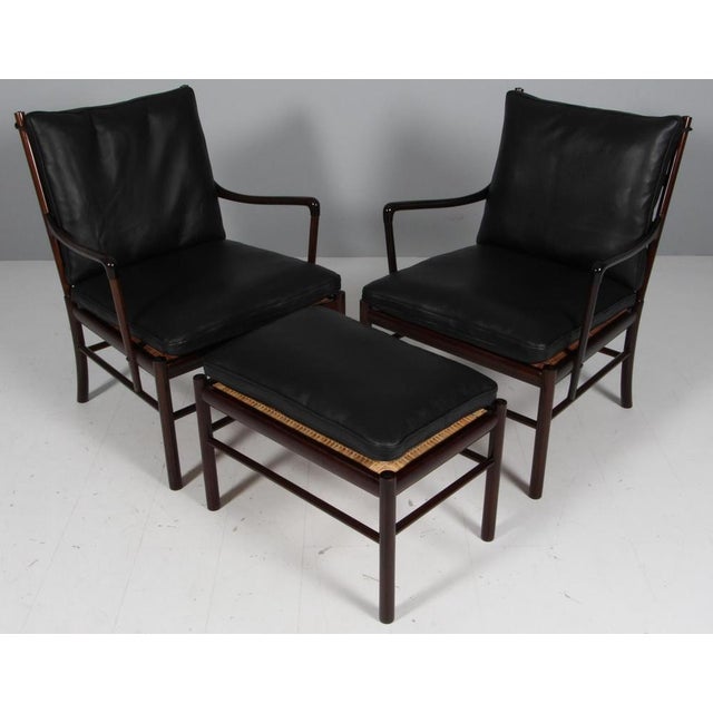 Ole Wanscher pair of lounge chairs and ottoman and new upholstered with black pure full grain aniline leather. Made in...