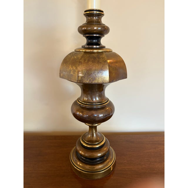 This distinctive Hollywood Regency Westwood lamp features a two tone finish in variegated bronze with polished brass...