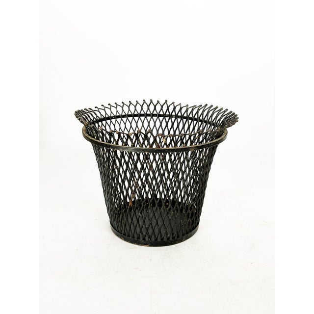 Perforated metal plant stand attributed to Mathieu Matégot, France, 1950s. This elegant black lacquered metal plant stand...