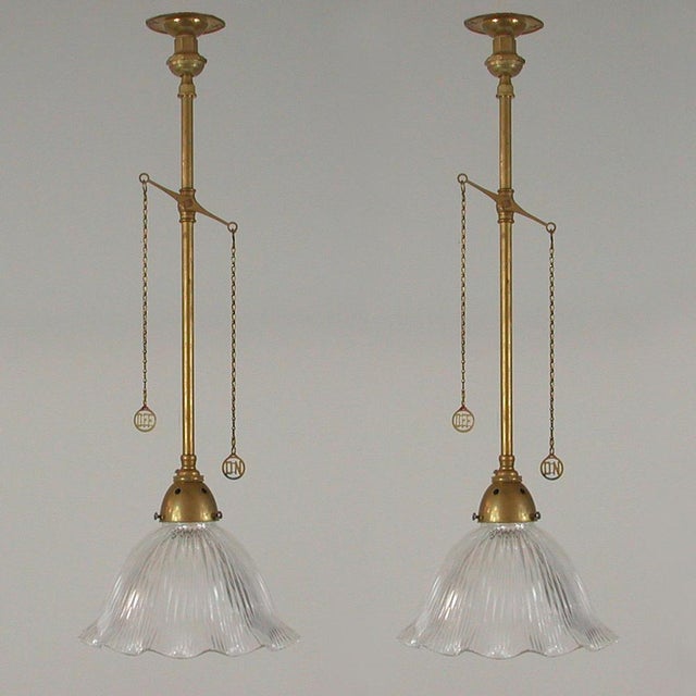These unusual vintage pendants were designed and manufactured in England in the 1920s. They feature clear glass Holophane...