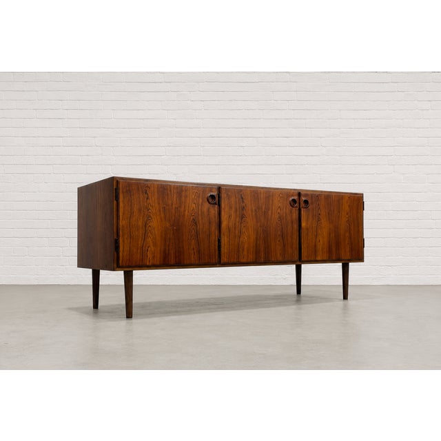 Mid Century Modern Danish Rosewood credenza Sven Ellekaer for Albert Hansen Mobelfabrik, featuring breathtaking...