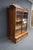 Victorian Eastlake bookcase in walnut with striking burl wood accents. The upper case features two glass doors opening to...