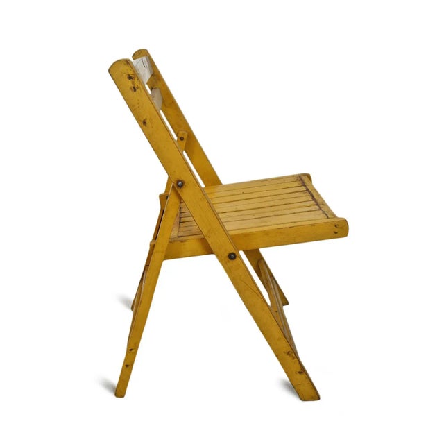 Antique yellow painted wooden folding chair from India. Each is unique and sold individually. Seat height is 18.5".