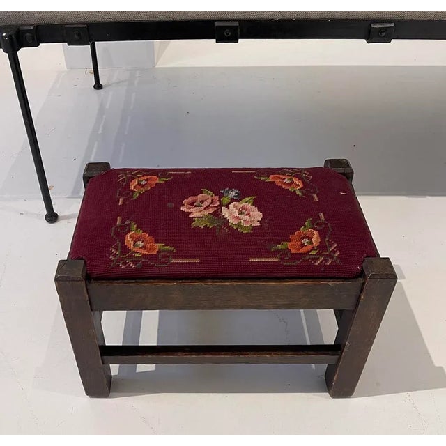 Charming vintage footstool featuring a solid oak frame and original hand-stitched floral needlepoint upholstery in rich...