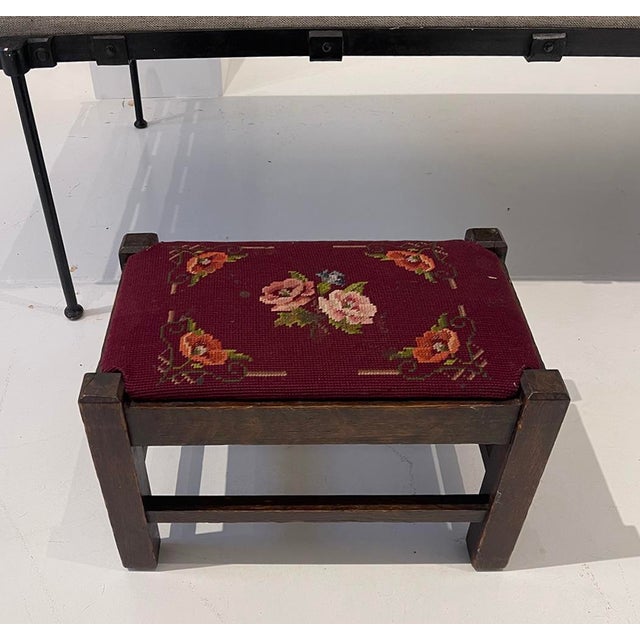 Charming vintage footstool featuring a solid oak frame and original hand-stitched floral needlepoint upholstery in rich...