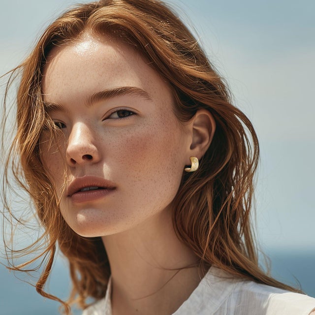 A quiet beam of light — the Meme Huggies capture the warmth of satin-brushed gold and the clarity of three bold diamonds....