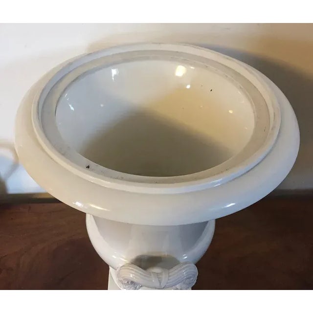 Large antique early 19th century French Empire Paris porcelain campagna urn in white glaze with mask loop handles....