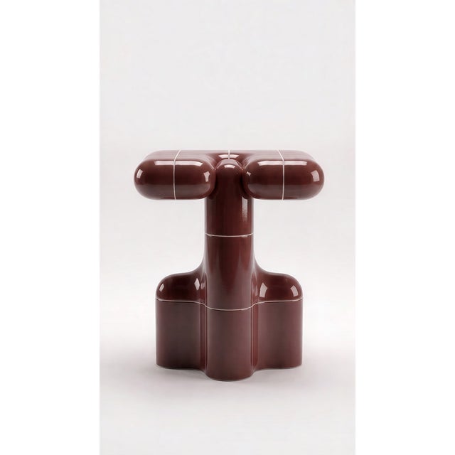 A side table with the presence of a small monument. Stacked curved tiles give it a silhouette that changes from every...