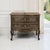 An antique Country French Regence commode handcrafted from French walnut, its warm, mellow patina glowing across a gently...