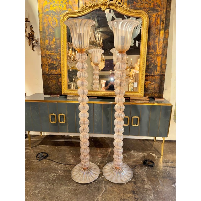 This product is a pair of Murano opalescent pink ball floor lamps, perfect for any room. The unique and elegant design of...