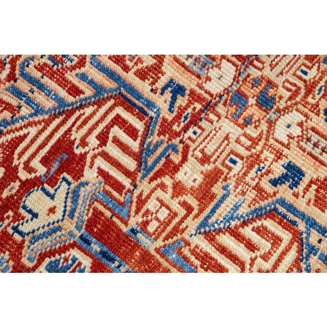 The antique Heriz rug exudes timeless elegance and sophistication with its premium hand-knotted wool and striking all-over...