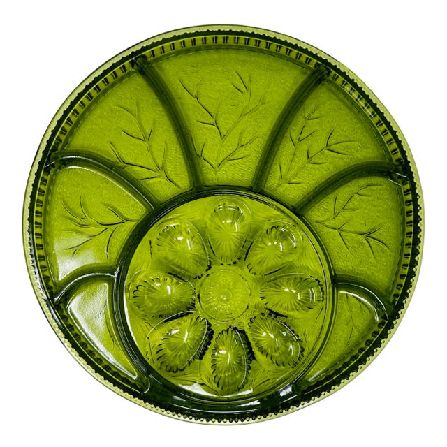 The platter features a circular shape with a raised center section designed specifically for holding deviled eggs. The...