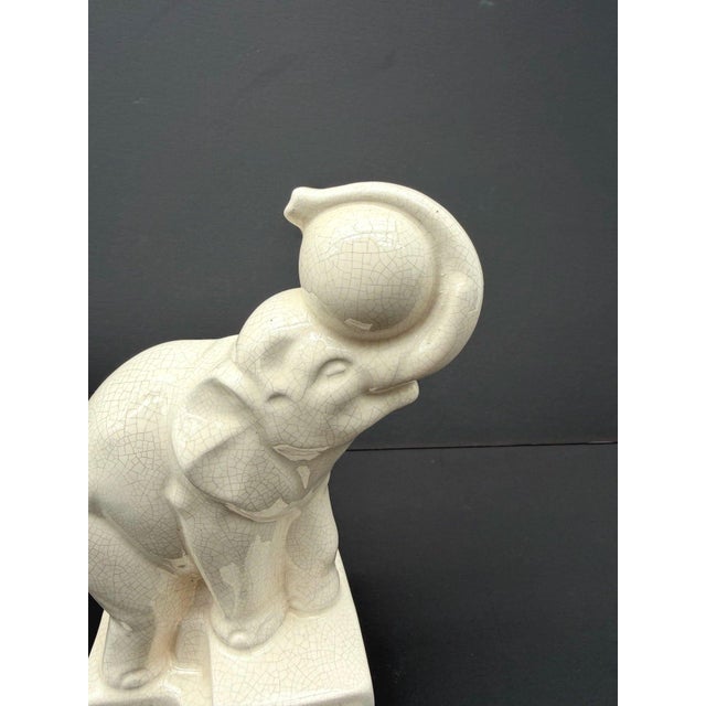 Art Deco Elephant with Balloon in Glazed and Crackled Earthenware by Duquenne for Longwy, 1930s, in Very Good conditions....