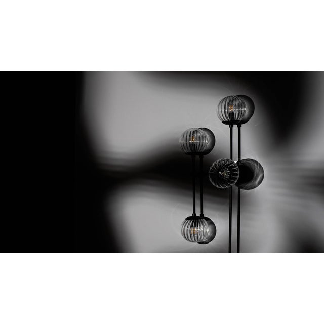 Armstrong 6 captures a sense of movement. Forms connect with spontaneous energy, punctuated by glass spheres. Linear...