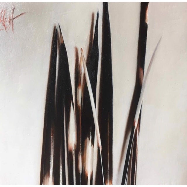 Quills presents a striking arrangement of elongated, dark forms that evoke the essence of quills against a soft, muted...