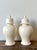 This elegant pair of vintage lidded urns brings a sense of refined Neoclassical grace and Hollywood Regency glamour to any...