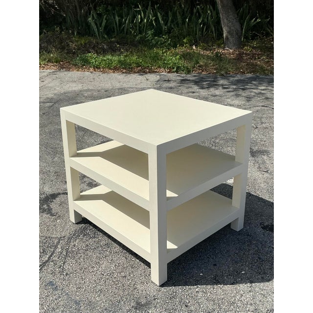 This elegant vintage Regency side table features a sophisticated stacked design, finished in a creamy lacquered coating...